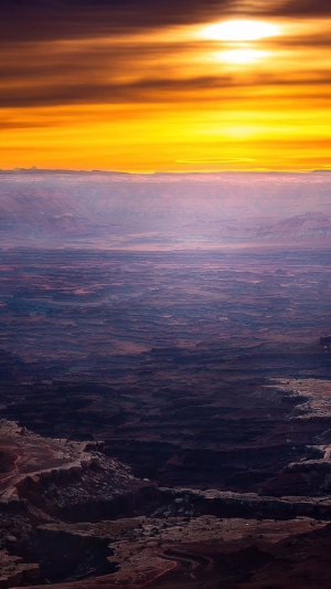 Sunset over a vast canyon landscape