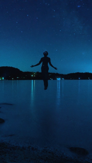 Silhouette of a person under a starry sky