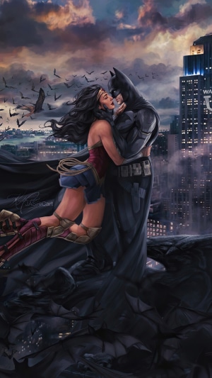 Wonder Woman and Batman embracing on a rooftop at dusk