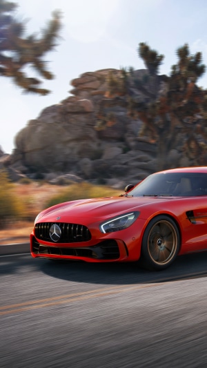 Red Mercedes-AMG GT R driving on a desert road