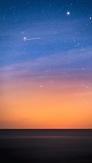 Stars over the ocean at dusk
