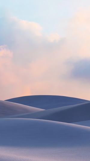 Desert dunes under pastel sky