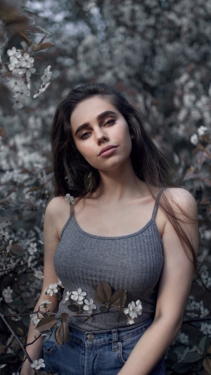 Young woman in a grey tank top and jeans