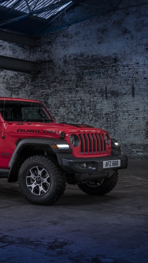 Red Jeep Wrangler Rubicon parked in a garage