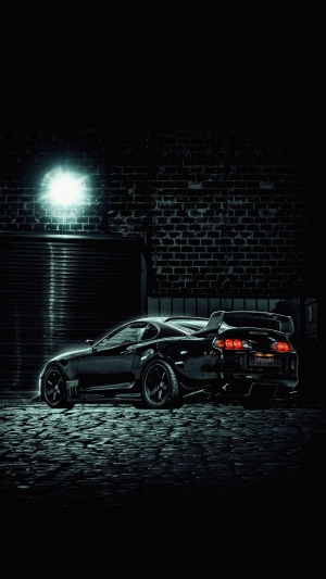 Black Toyota Supra Sports Car at Night