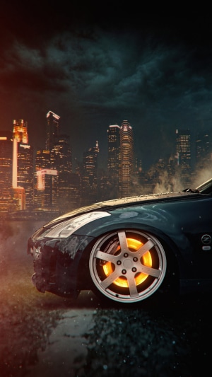 Car with glowing brakes in a city at night