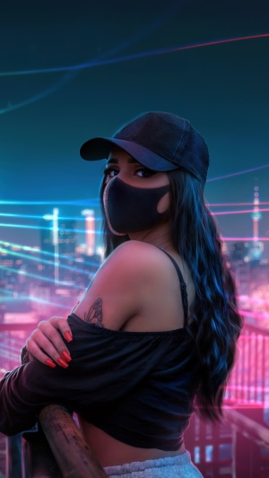 Girl in a black cap and mask with neon lights