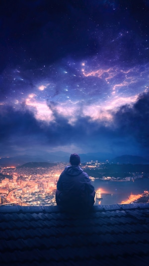 Person sitting on a rooftop overlooking a city at night