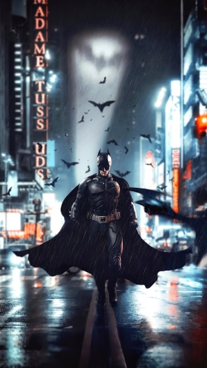 Batman in a rainy city with bats