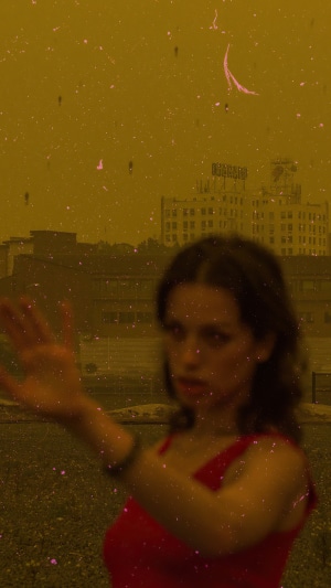 Woman in red dress with buildings in background