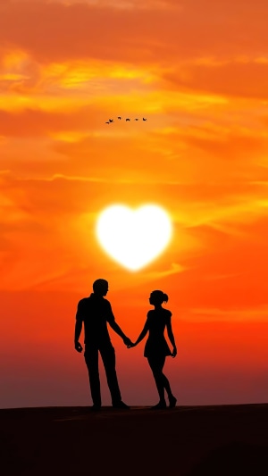 Couple holding hands at sunset with heart-shaped sun