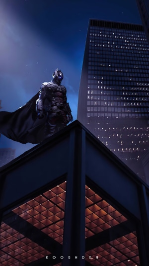 Batman from DC Comics standing on a skyscraper rooftop at night