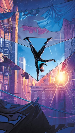 Nightwing performing a handstand between buildings