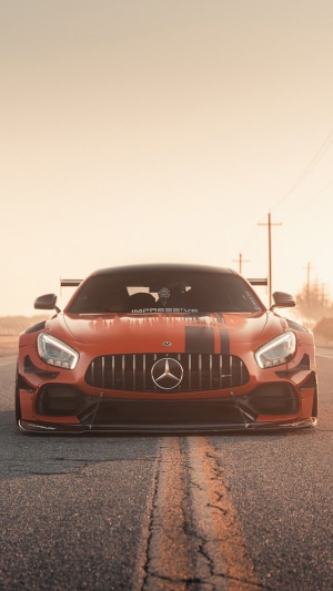 Orange Mercedes-AMG GT R with racing stripes on road