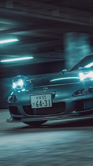 Mazda RX-7 with pop-up headlights in a parking garage