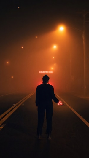 Person on foggy road with neon sign