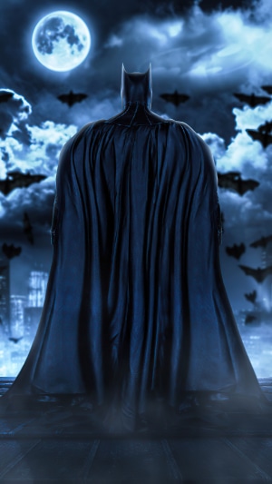 Batman standing on a rooftop at night