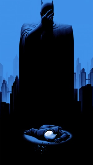Batman standing over fallen Joker in Gotham City