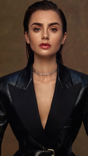 Lily Collins in a black blazer with a choker necklace