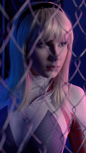 Gwen Stacy cosplay behind a fence