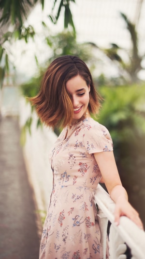 Holly Earl smiling in a floral dress