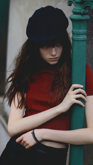 Girl wearing a black hat and red shirt