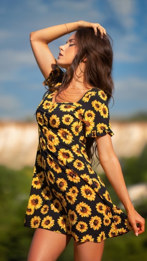 Woman in sunflower dress outdoors