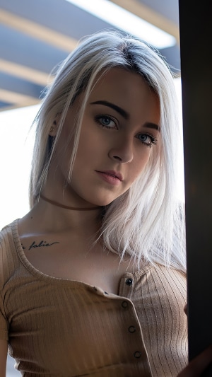 Young woman with blonde hair and tattoo