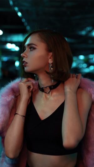 Model in pink fur jacket and black top