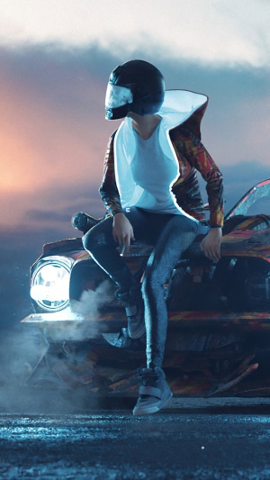 Person in helmet sitting on a car