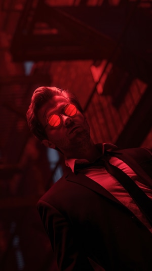 Man in suit with red sunglasses