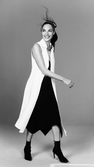 Gal Gadot in a black dress and white vest