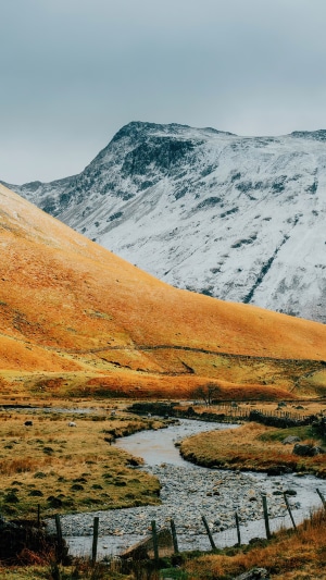 Snow-capped mountains and a winding stream in a valley