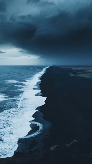 Dark stormy clouds over a black sand beach in Iceland