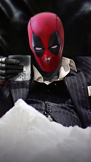 Deadpool in a suit holding a drink with white powder