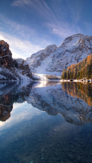 Snowy mountains reflected in a clear lake