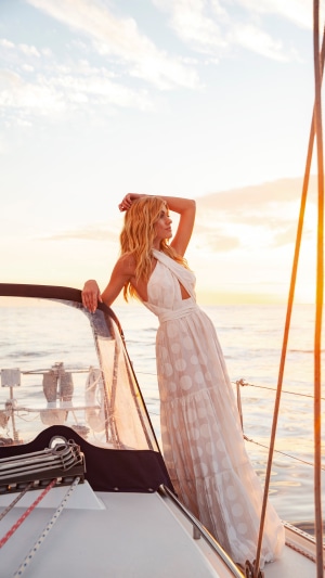 Katherine McNamara on a sailboat at sunset