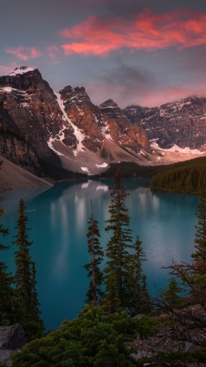 Turquoise lake and snow-capped mountains at sunset