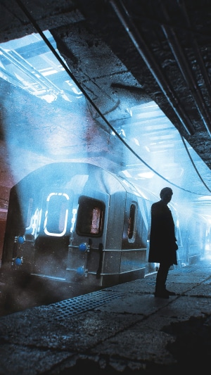 Man on a subway platform with a train