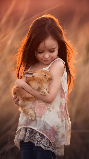 Little girl holding a rabbit