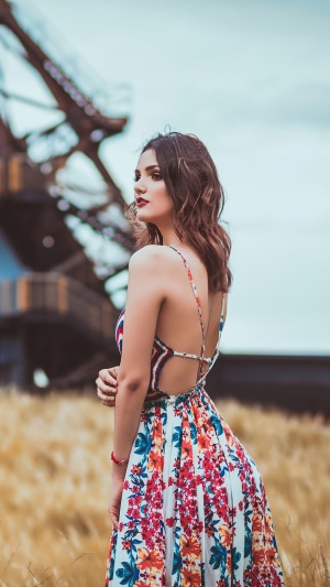 Woman in floral dress in a field