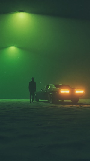Man standing next to a car with glowing taillights