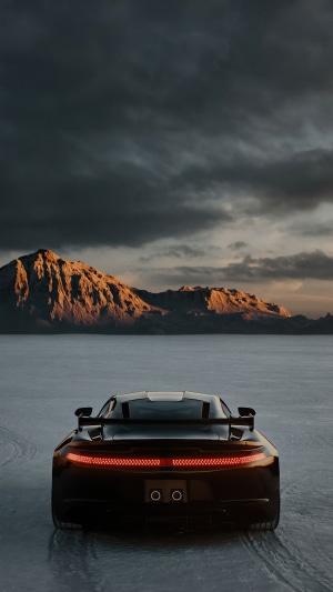 Black Saleen car on salt flats with mountains
