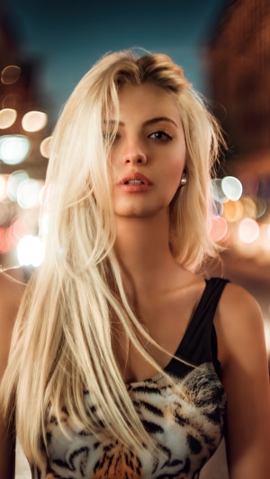 Blonde model with tiger print top at night