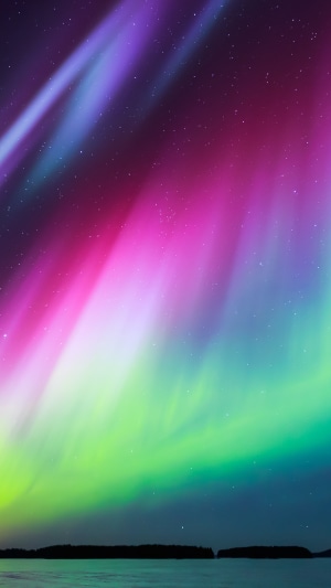 Aurora Borealis over water and land