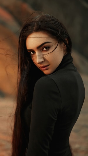 Woman in black dress with long dark hair