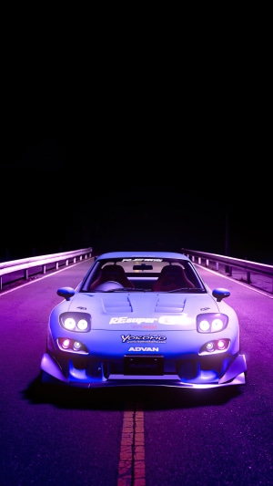 Mazda RX-7 with neon lighting on a road