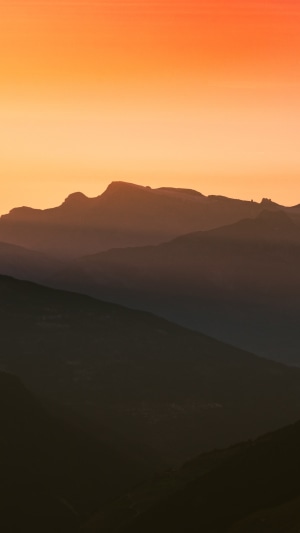 Mountains at sunset with orange sky