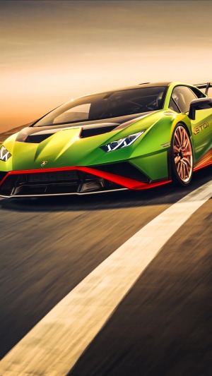 Green Lamborghini Huracan STO driving on a road