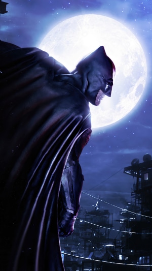 Batman on a rooftop with a full moon